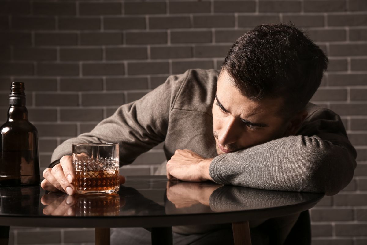man struggling with alcoholism drinks different types of liquor
