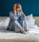 woman sitting in bed experiences trauma in her hips