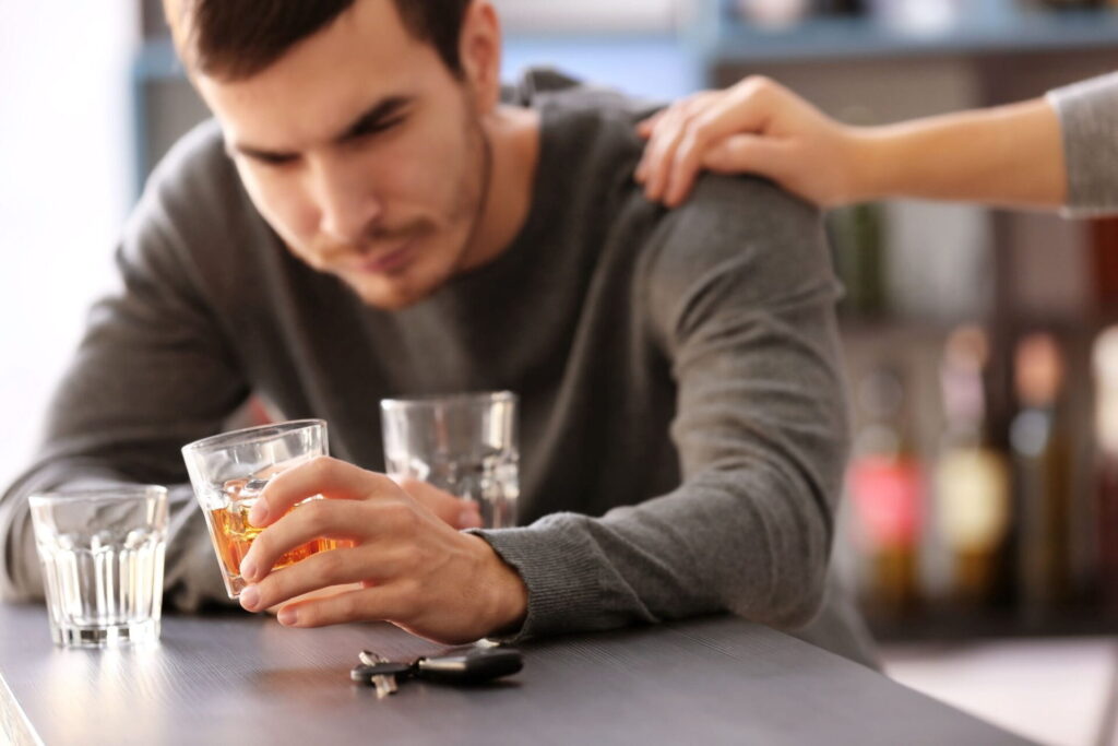 person drinking too much alcohol gets support from friend