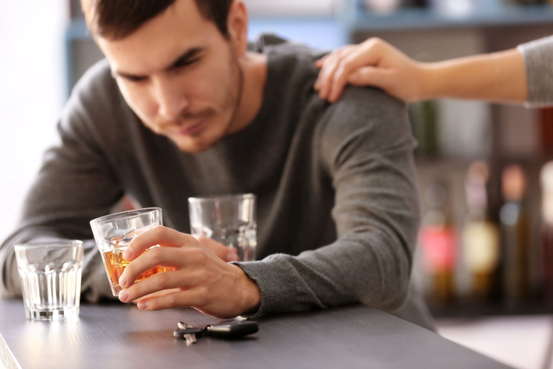 person drinking too much alcohol gets support from friend